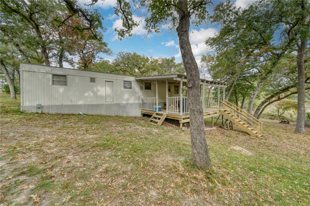 10232 Riley Green Road Franklin, TX 77856 - Photo 22 of 40 a backyard of a house with table and chairs