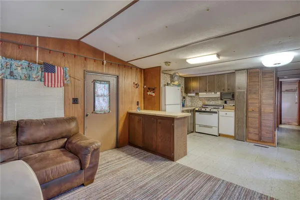a kitchen with a stove a refrigerator and a sink