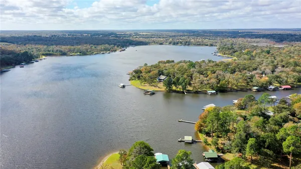 an aerial view of a houses with a yard