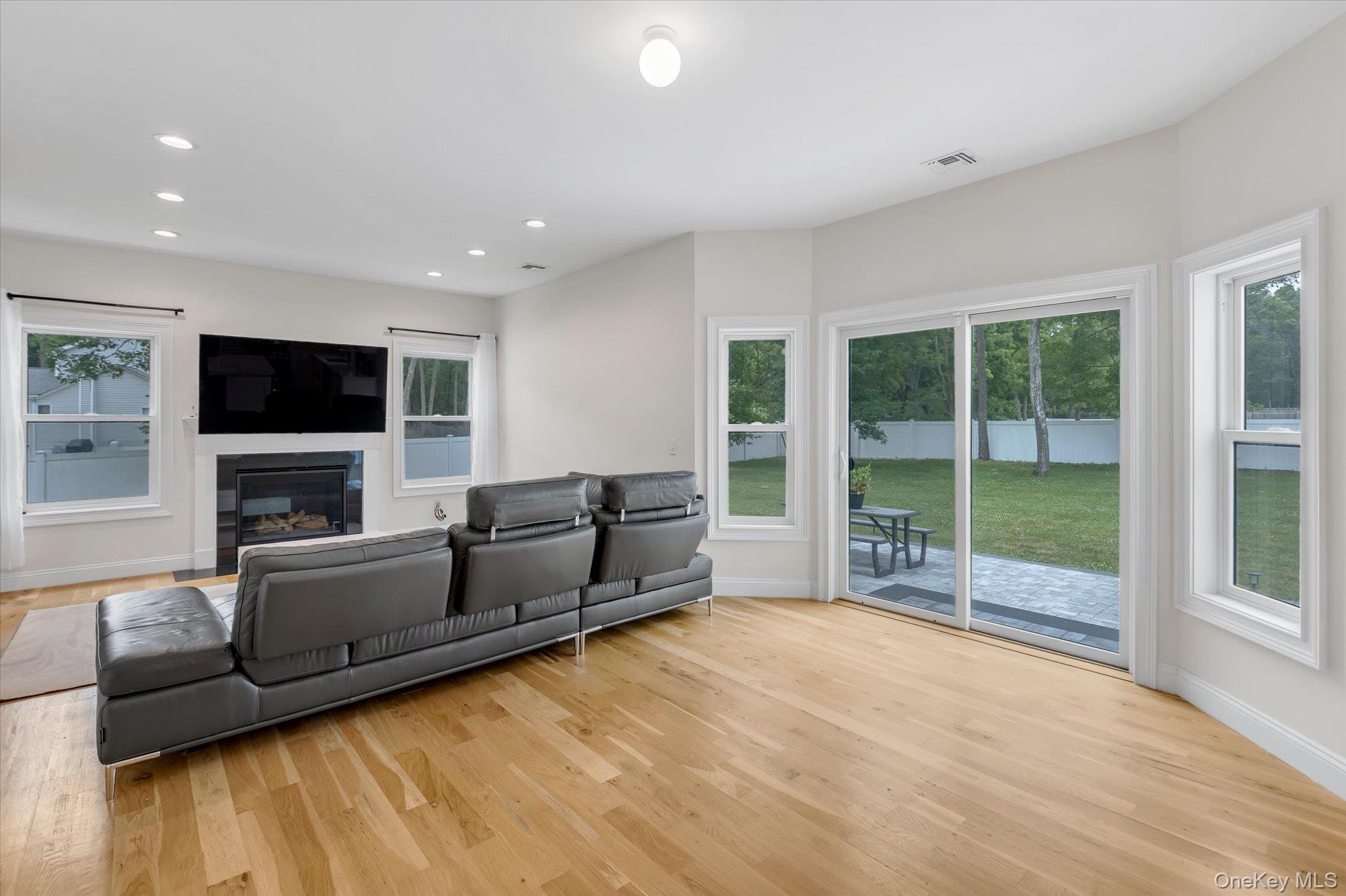 135 Elizabeth Way Ridge, NY 11961 - Photo 6 of 24 a living room with furniture and a flat screen tv