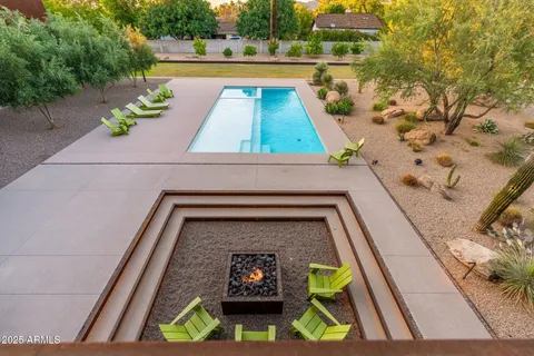 a view of a patio with swimming pool table and chairs