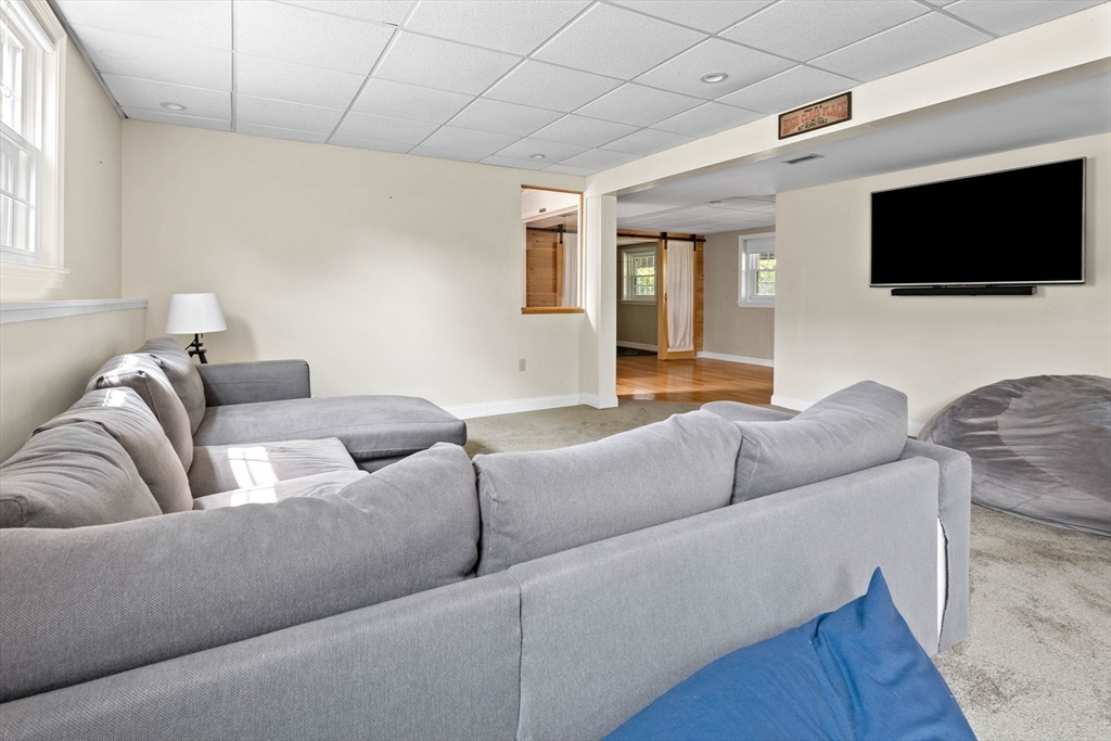 324 Hatherly Road Scituate, MA 02066 - Photo 11 of 15 a living room with furniture and a flat screen tv