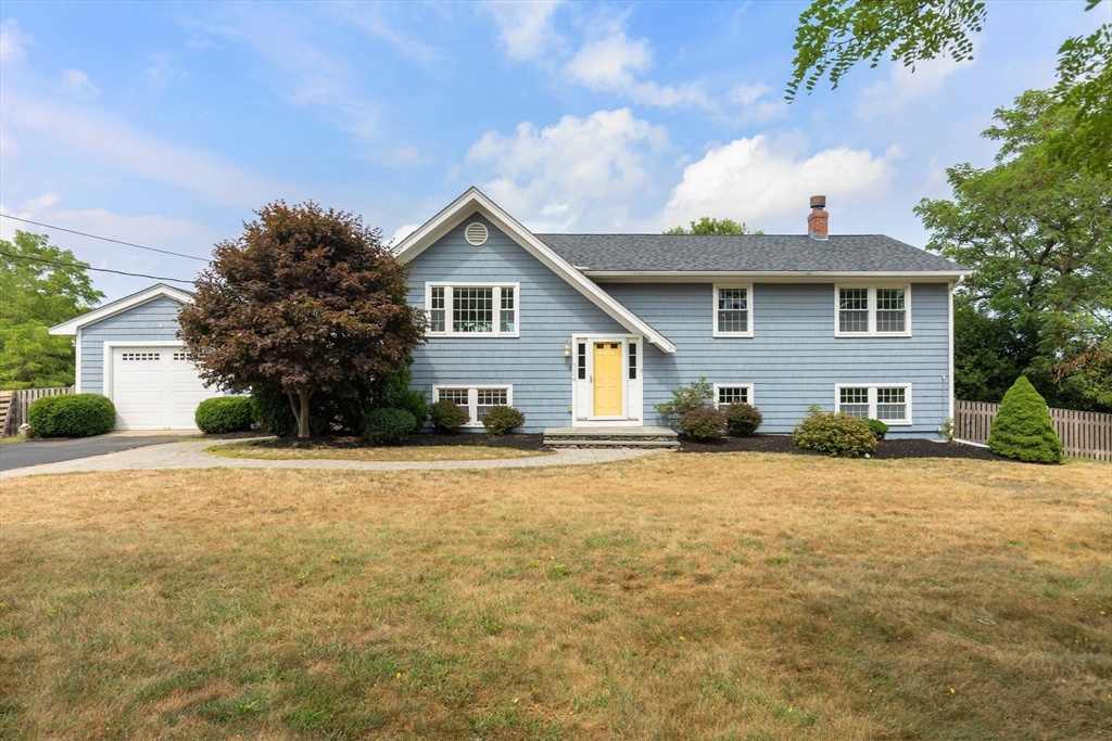 324 Hatherly Road Scituate, MA 02066 - Photo 3 of 15 a front view of a house with a yard and garage