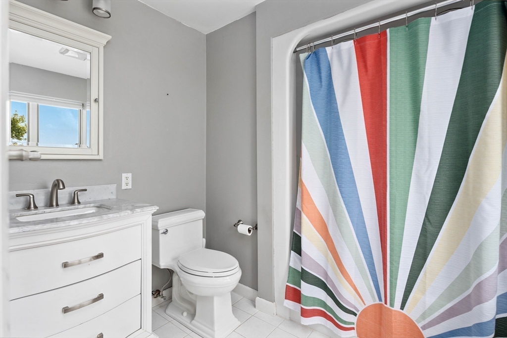 324 Hatherly Road Scituate, MA 02066 - Photo 10 of 15 a bathroom with a sink a toilet and a mirror