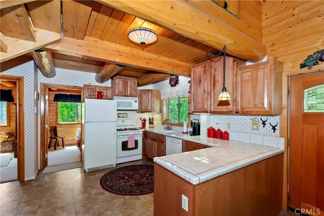 a kitchen with a stove a refrigerator and a sink