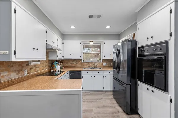 a kitchen with stainless steel appliances granite countertop a refrigerator and a stove