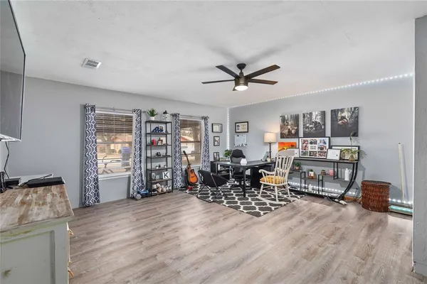 a living room with furniture and a wooden floor