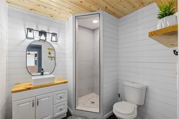 a bathroom with a toilet a sink and mirror