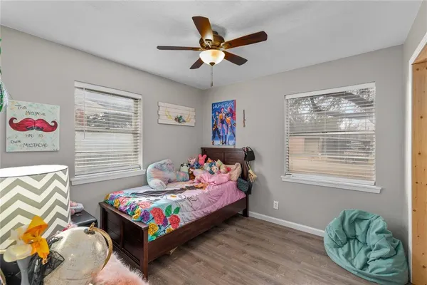 a bedroom with a bed window and couch