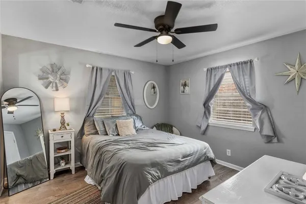 a bedroom with a bed and a chandelier