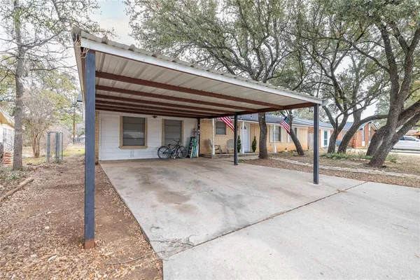 a view of a house with a backyard and trees