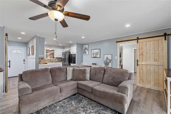 a view of living room kitchen with furniture and a ceiling fan