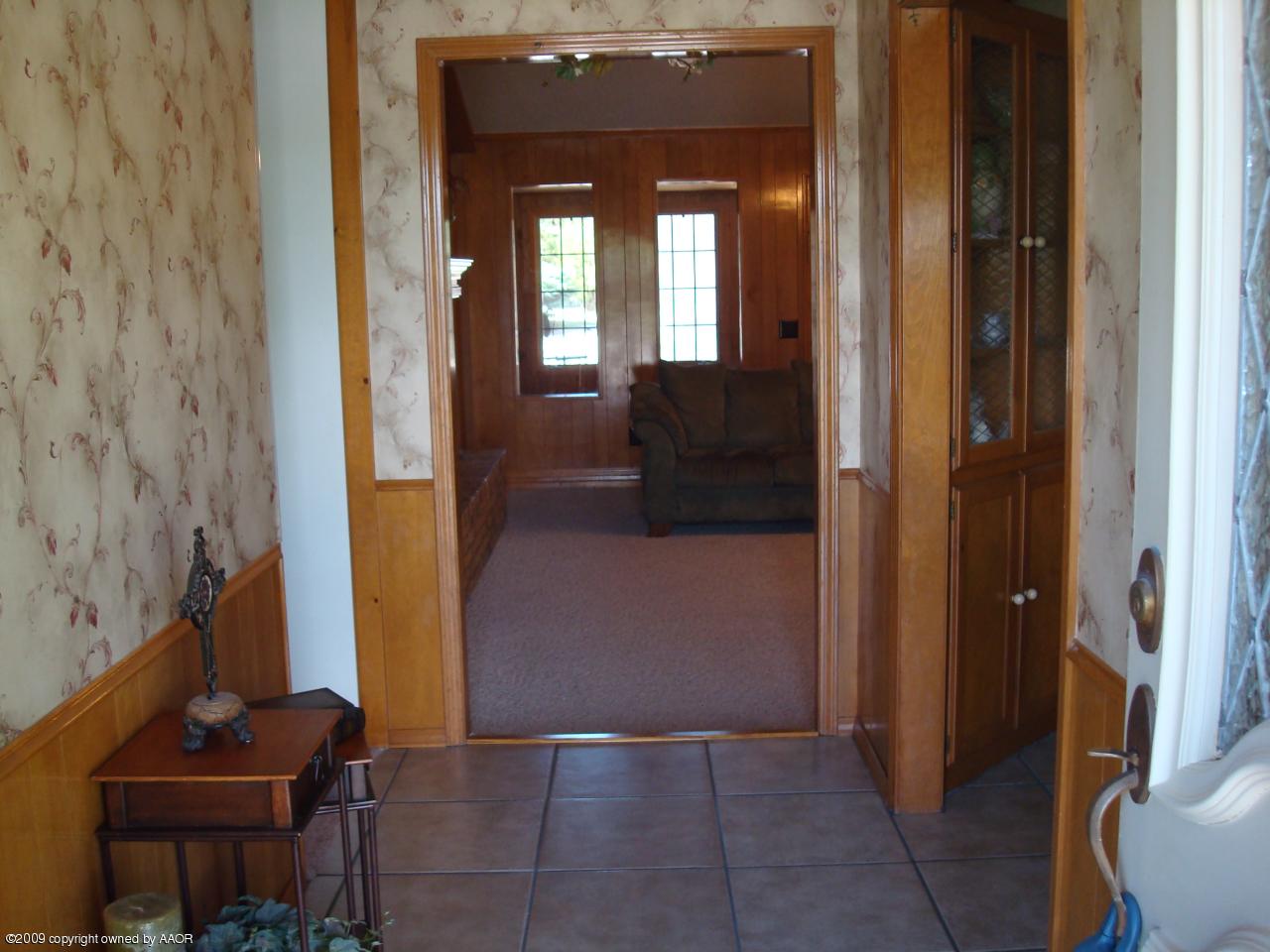 5100 Navajo Trail Amarillo, TX 79110 - Photo 3 of 23 a view of a hallway with wooden floor and a living room