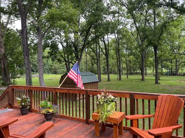 a view of a deck with a table and chairs with wooden fence and floor