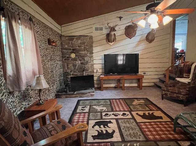a picture of a living room with a fireplace and a flat screen tv