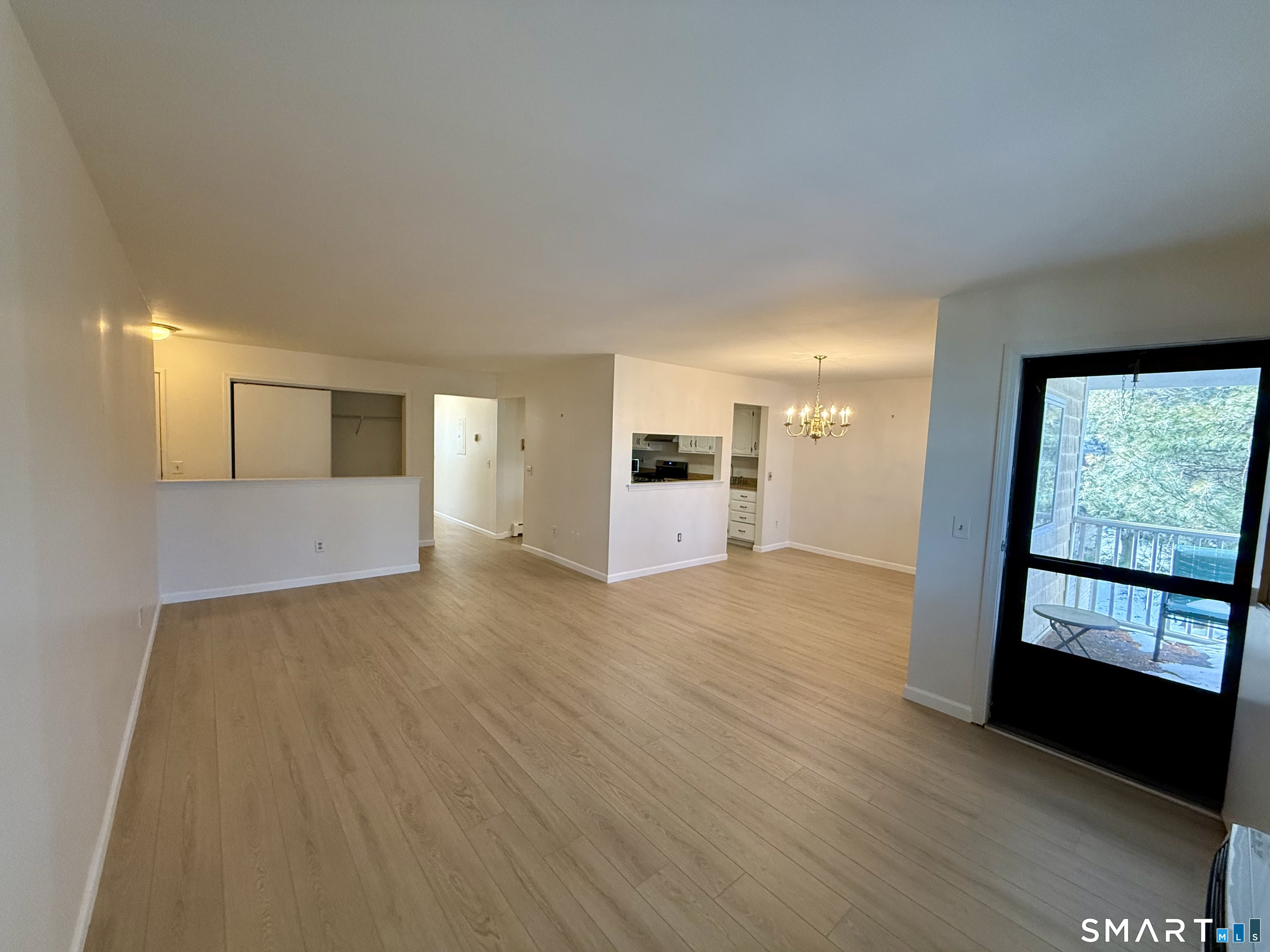 2955 Madison Avenue, Unit 4 Bridgeport, CT 06606 - Photo 3 of 15 a view of empty room with wooden floor and fan