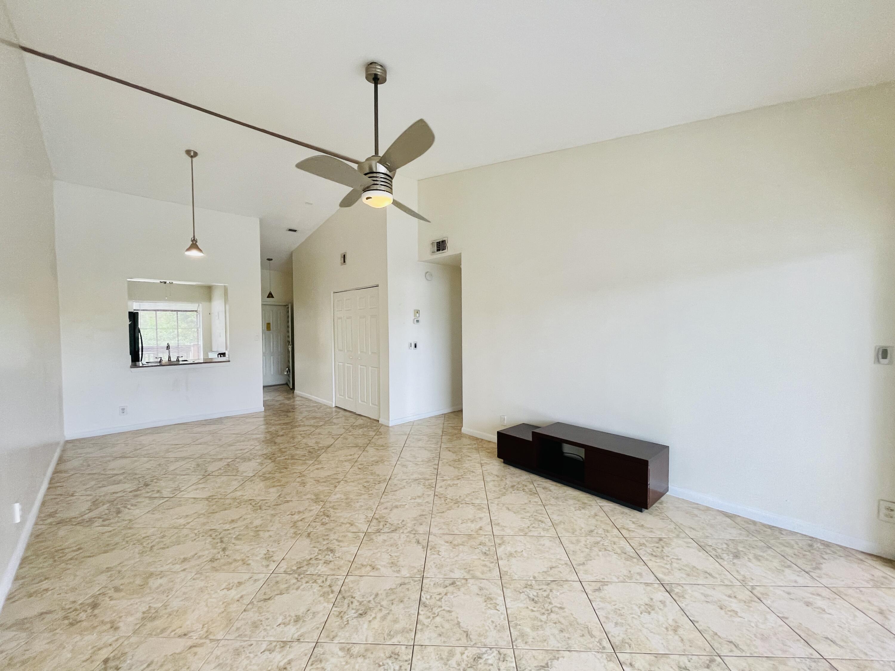 2297 Southwest 15th Street, Unit 122 Deerfield Beach, FL 33442 - Photo 12 of 47 a view of empty room with a ceiling fan