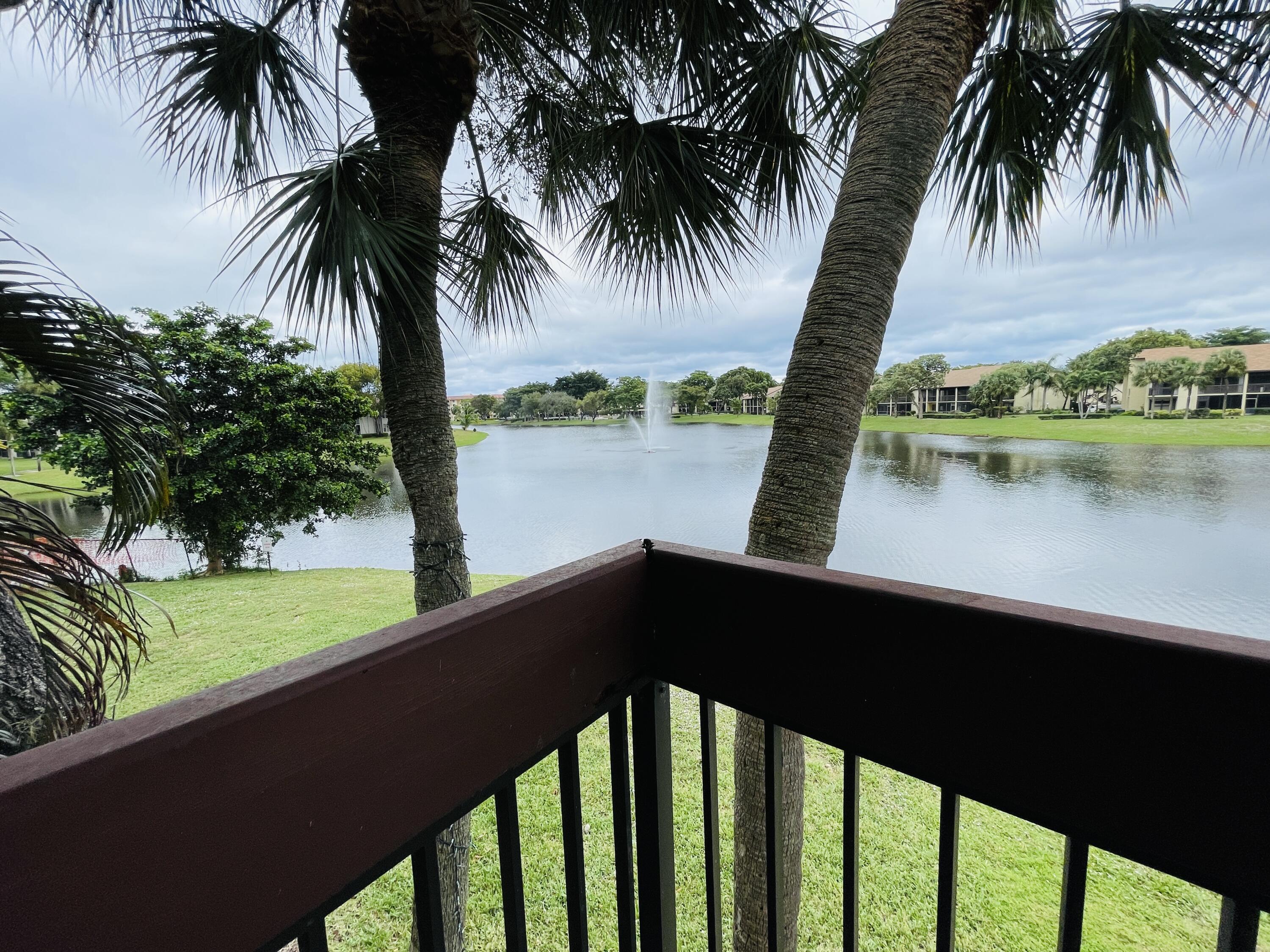 2297 Southwest 15th Street, Unit 122 Deerfield Beach, FL 33442 - Photo 19 of 47 a view of a lake and a yard