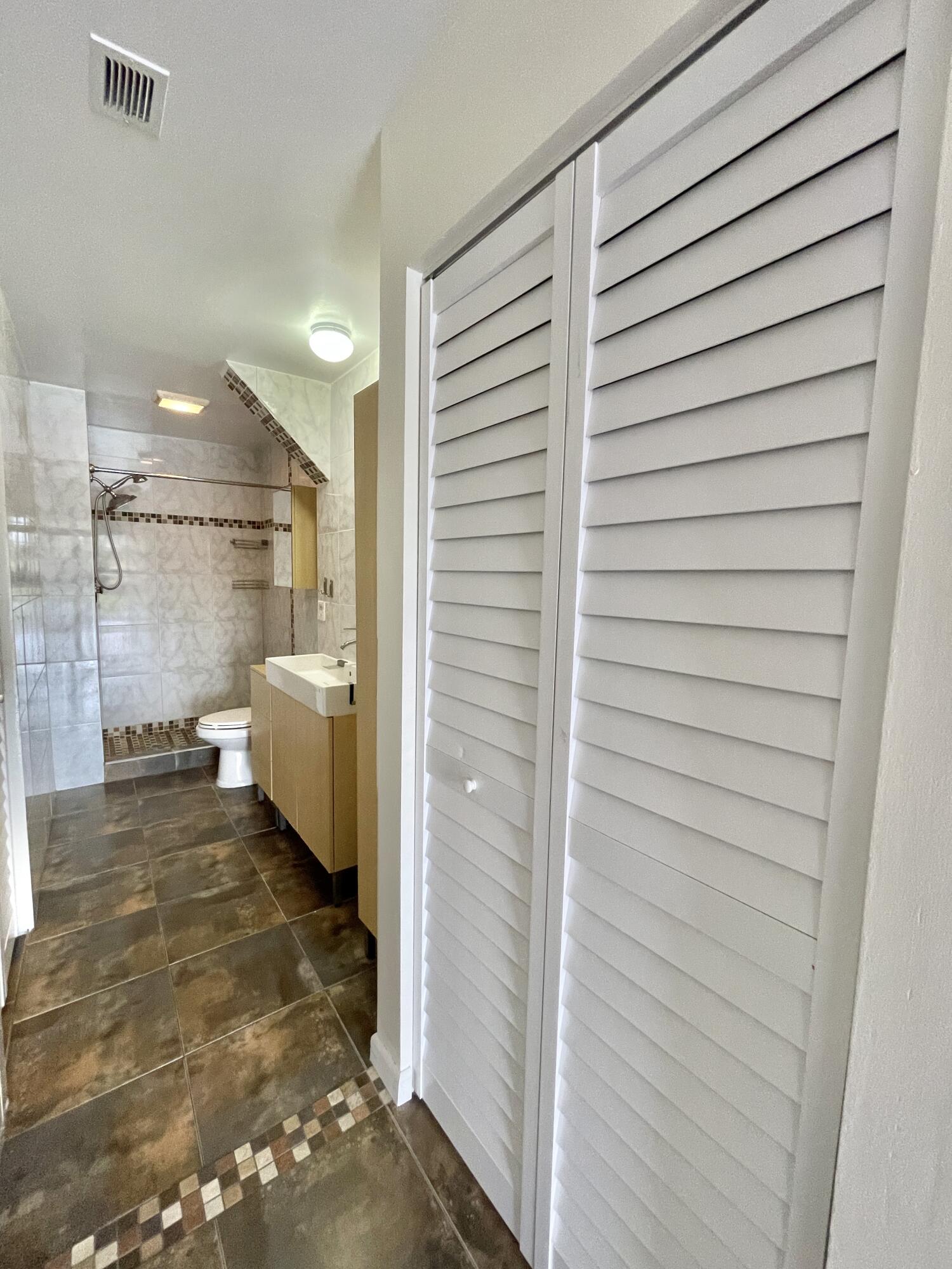 2297 Southwest 15th Street, Unit 122 Deerfield Beach, FL 33442 - Photo 20 of 47 a bathroom with a sink and a shower
