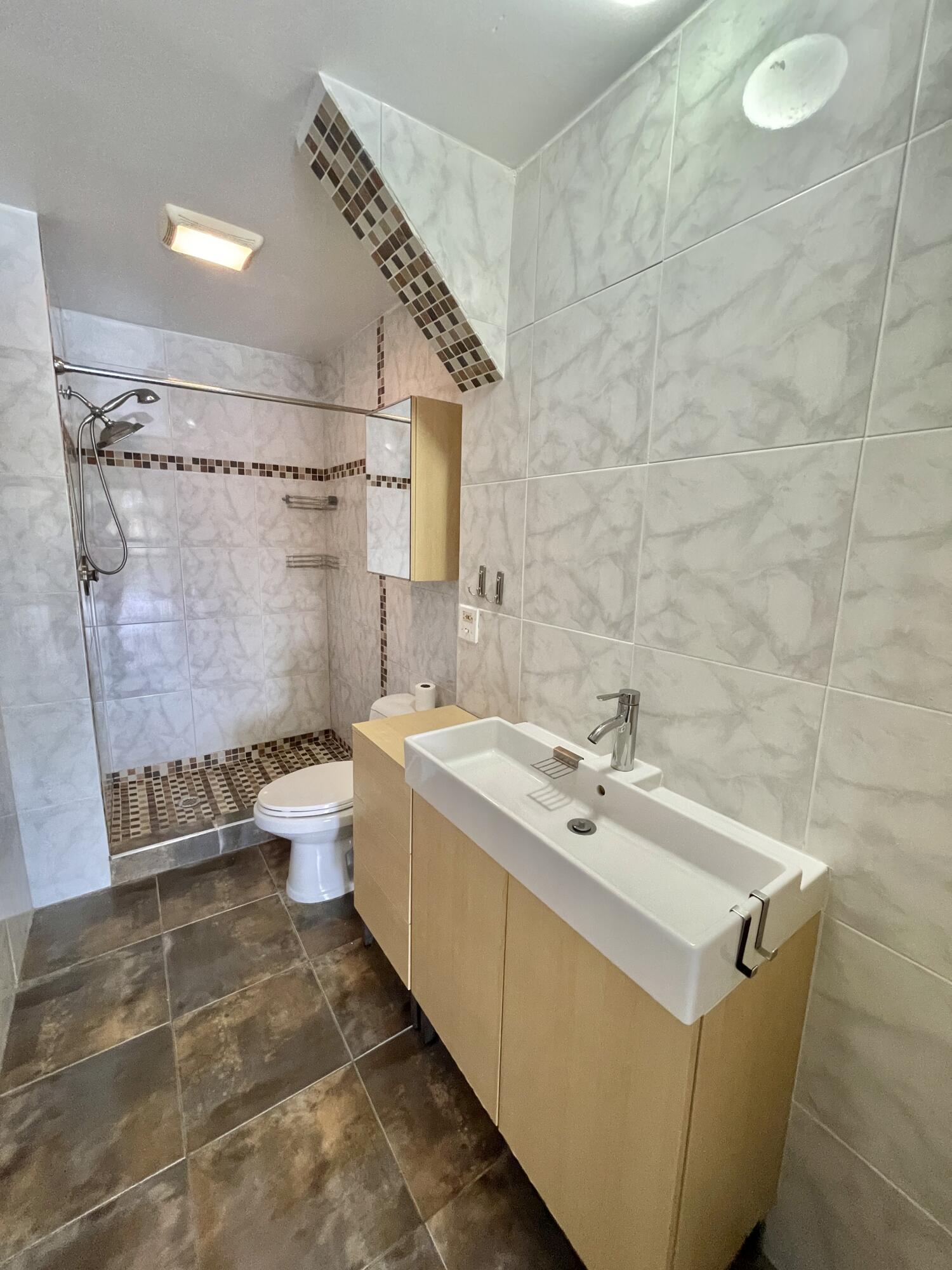 2297 Southwest 15th Street, Unit 122 Deerfield Beach, FL 33442 - Photo 21 of 47 a bathroom with a sink a toilet and shower