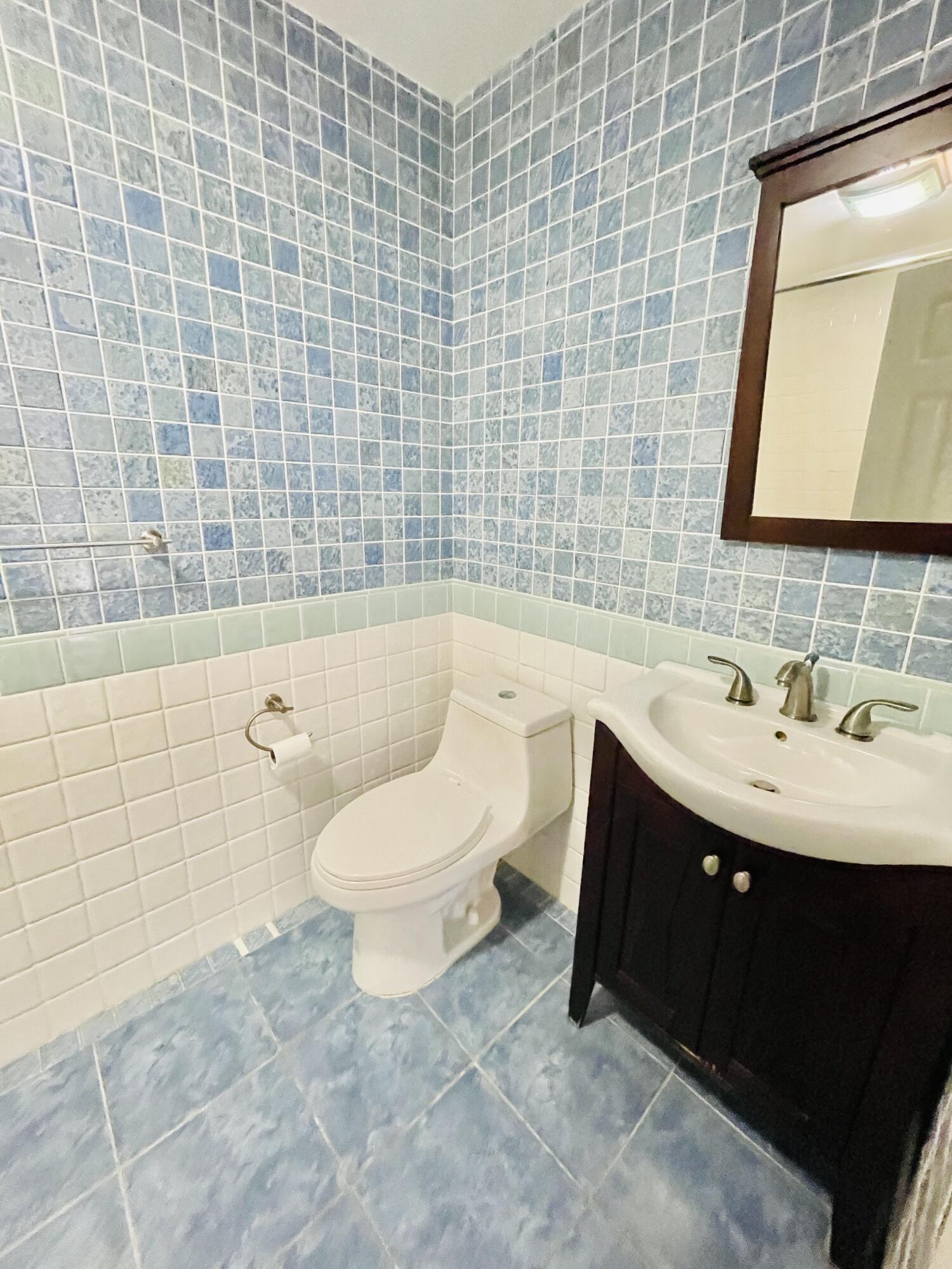 2297 Southwest 15th Street, Unit 122 Deerfield Beach, FL 33442 - Photo 24 of 47 a bathroom with a sink toilet and shower