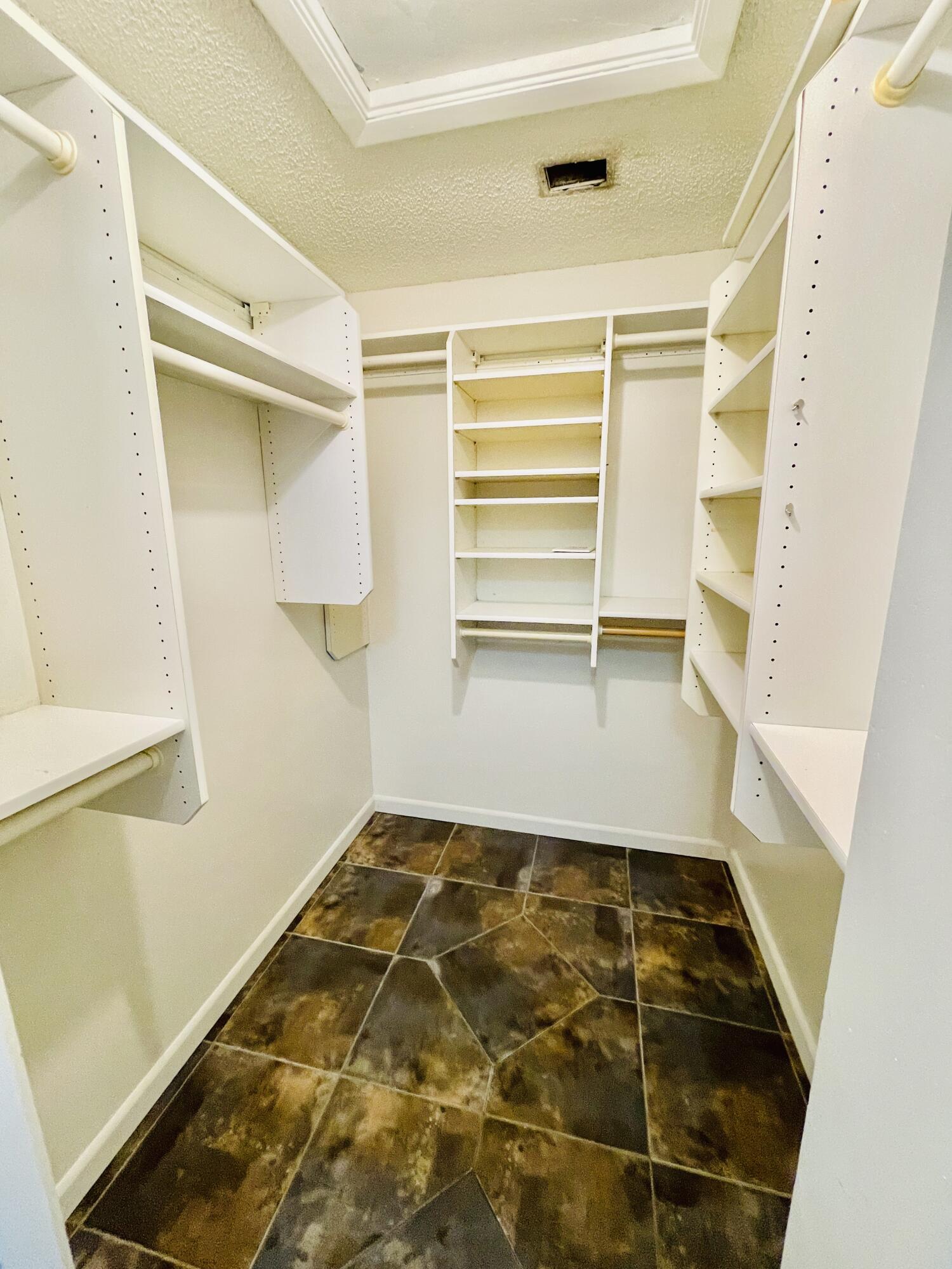 2297 Southwest 15th Street, Unit 122 Deerfield Beach, FL 33442 - Photo 25 of 47 a view of walk in closet with empty racks
