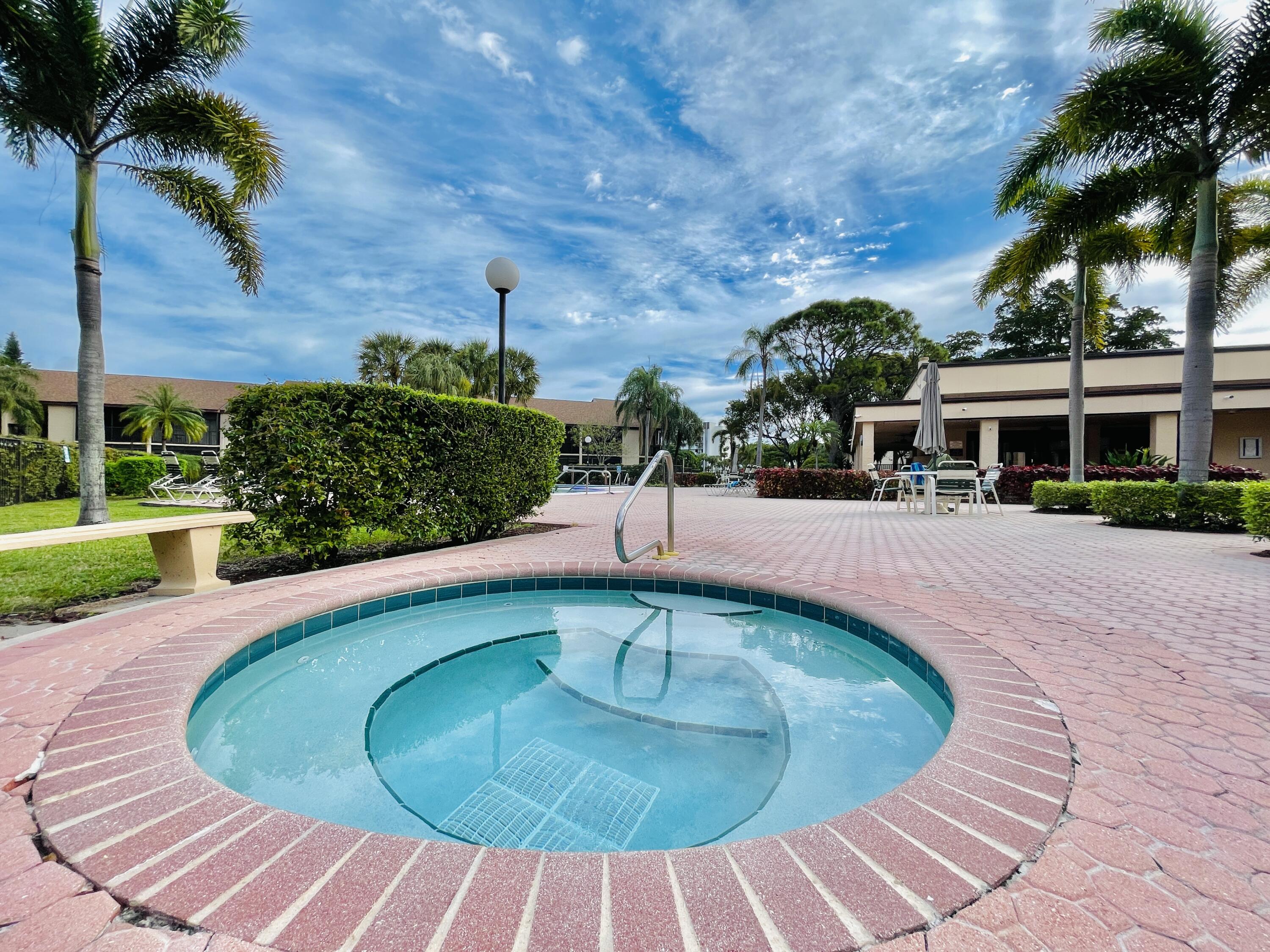 2297 Southwest 15th Street, Unit 122 Deerfield Beach, FL 33442 - Photo 30 of 47 a view of a swimming pool with a patio