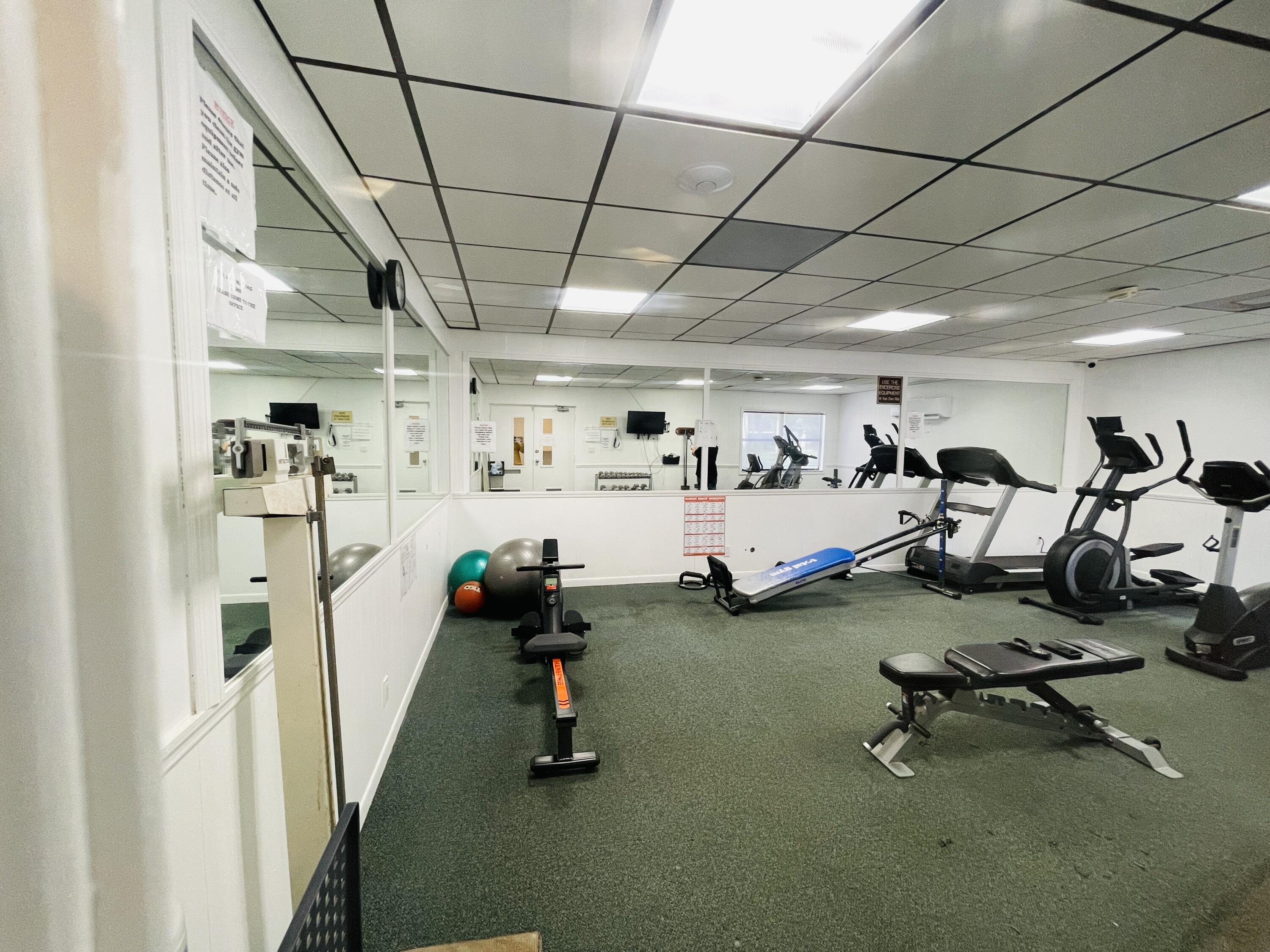 2297 Southwest 15th Street, Unit 122 Deerfield Beach, FL 33442 - Photo 31 of 47 a view of a room with gym equipment