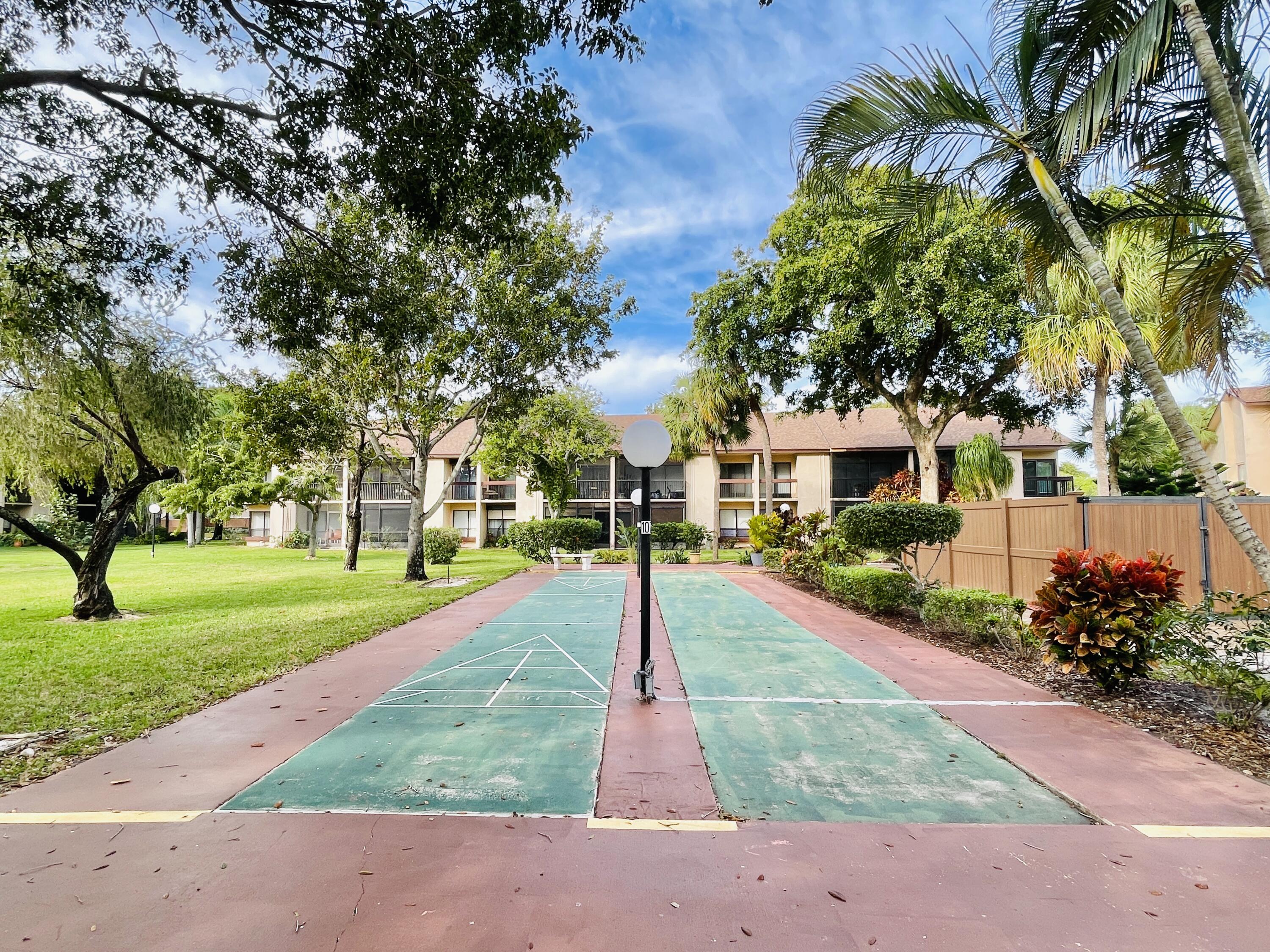 2297 Southwest 15th Street, Unit 122 Deerfield Beach, FL 33442 - Photo 32 of 47 a park with full of palm trees