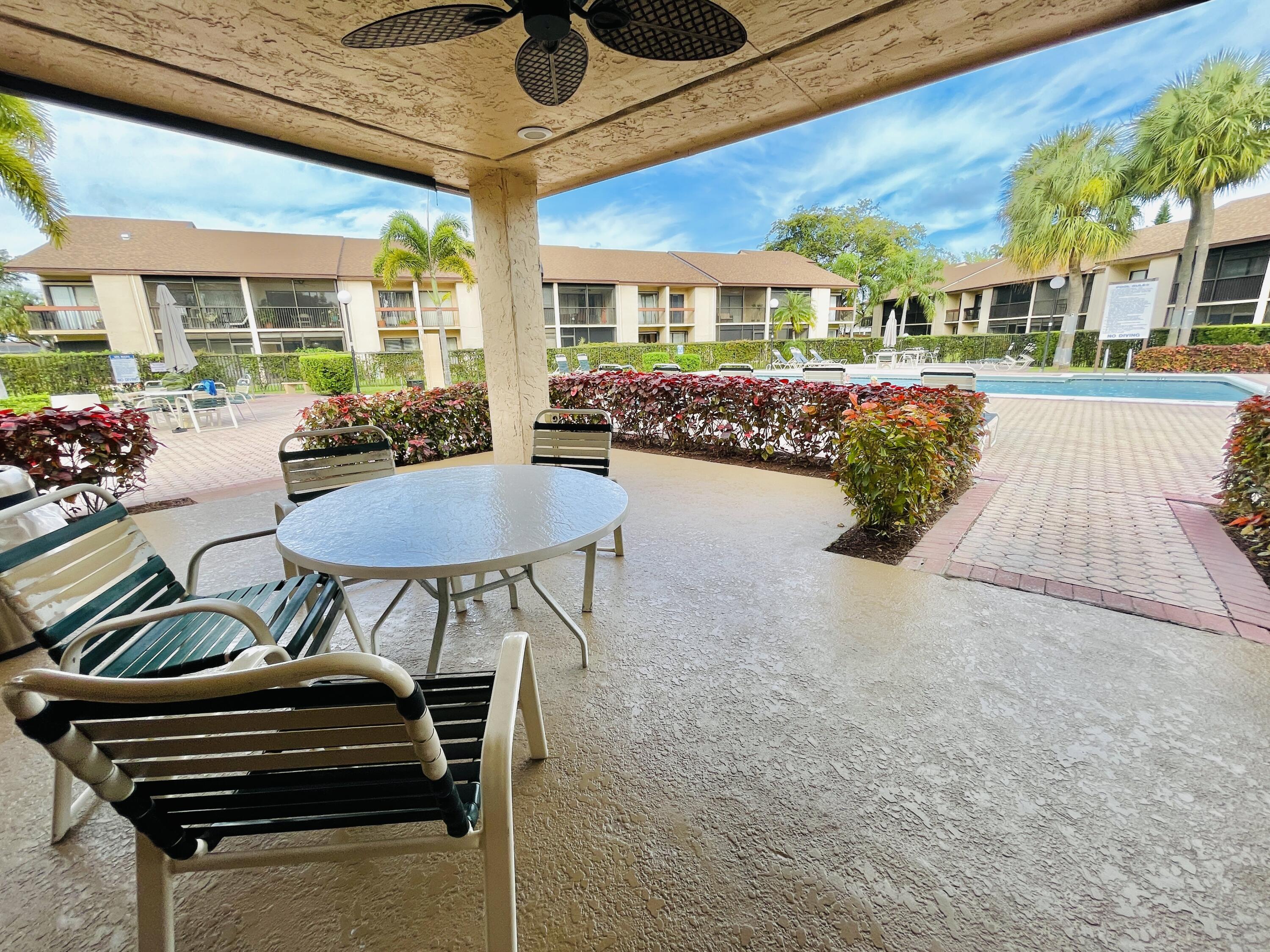 2297 Southwest 15th Street, Unit 122 Deerfield Beach, FL 33442 - Photo 36 of 47 a outdoor space with lots of tables and chairs