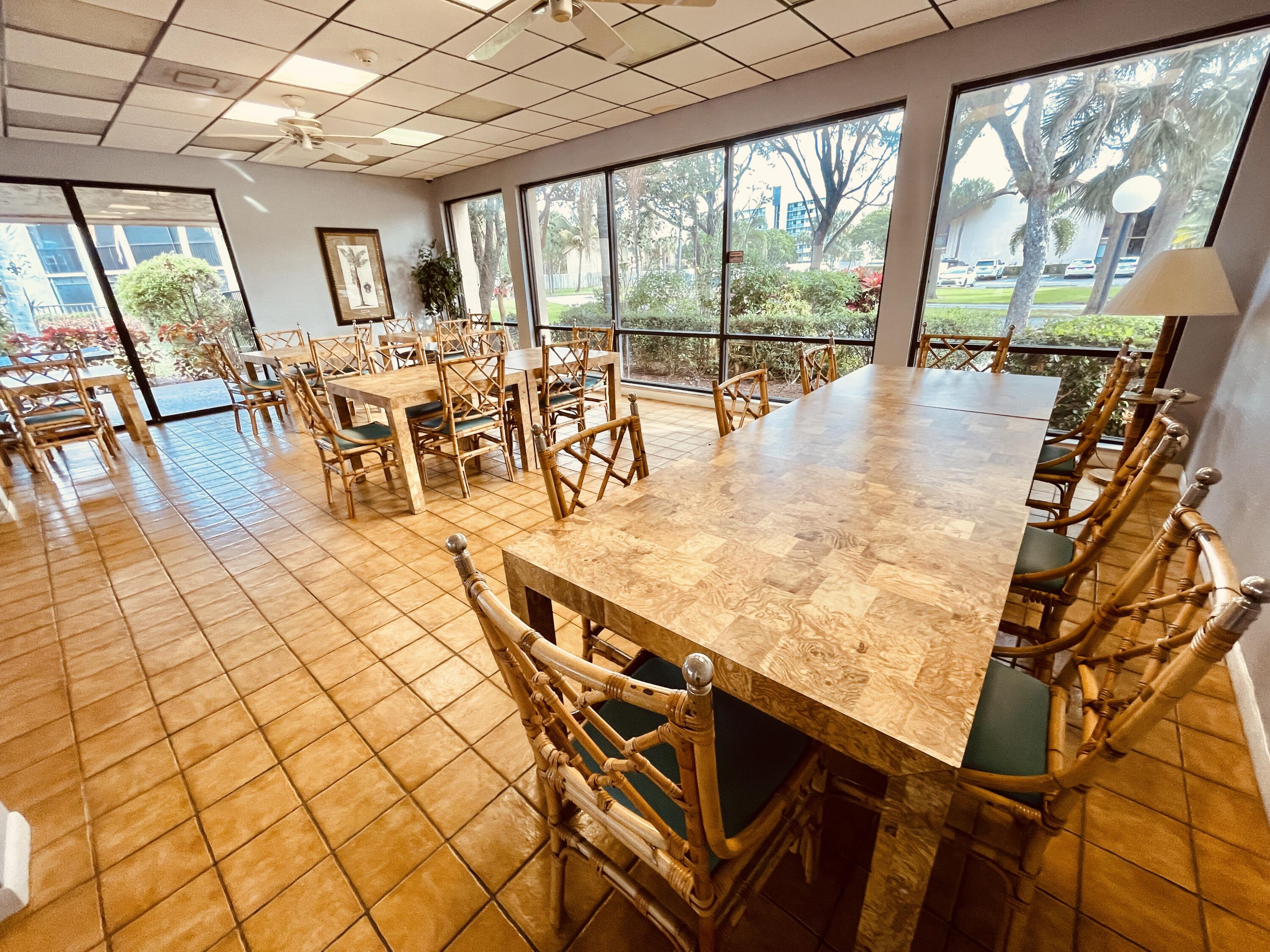 2297 Southwest 15th Street, Unit 122 Deerfield Beach, FL 33442 - Photo 39 of 47 a view of a living room and dining room with wooden floor