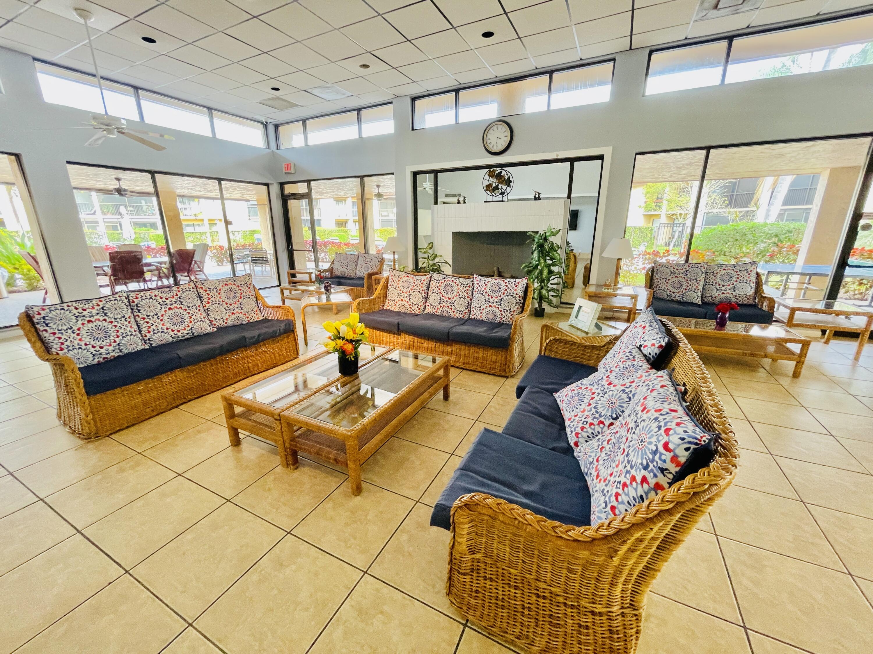 2297 Southwest 15th Street, Unit 122 Deerfield Beach, FL 33442 - Photo 41 of 47 a living room with patio furniture and a fireplace