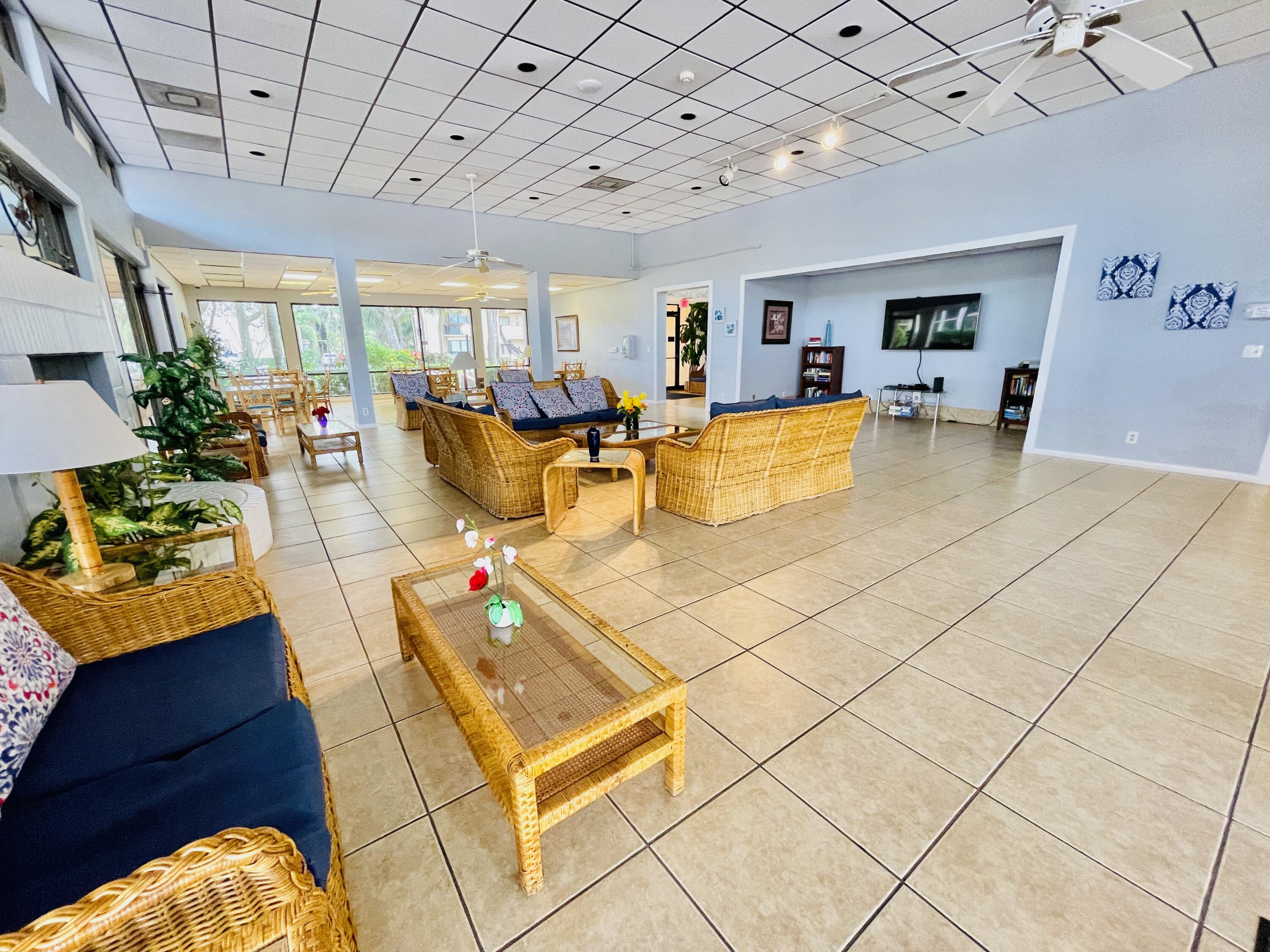 2297 Southwest 15th Street, Unit 122 Deerfield Beach, FL 33442 - Photo 44 of 47 a living room with furniture and a chandelier