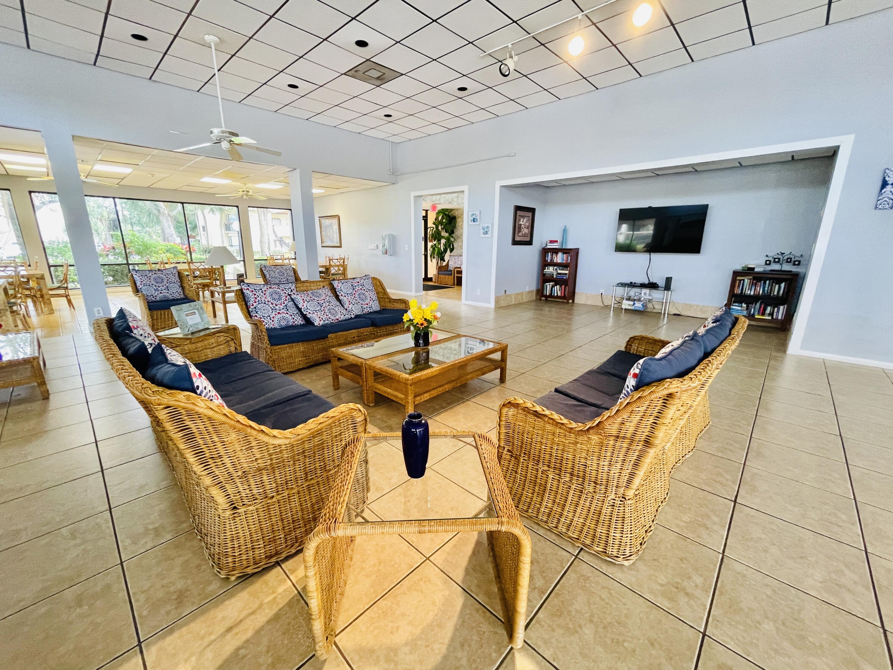 2297 Southwest 15th Street, Unit 122 Deerfield Beach, FL 33442 - Photo 45 of 47 a view of a livingroom with furniture and a flat screen tv