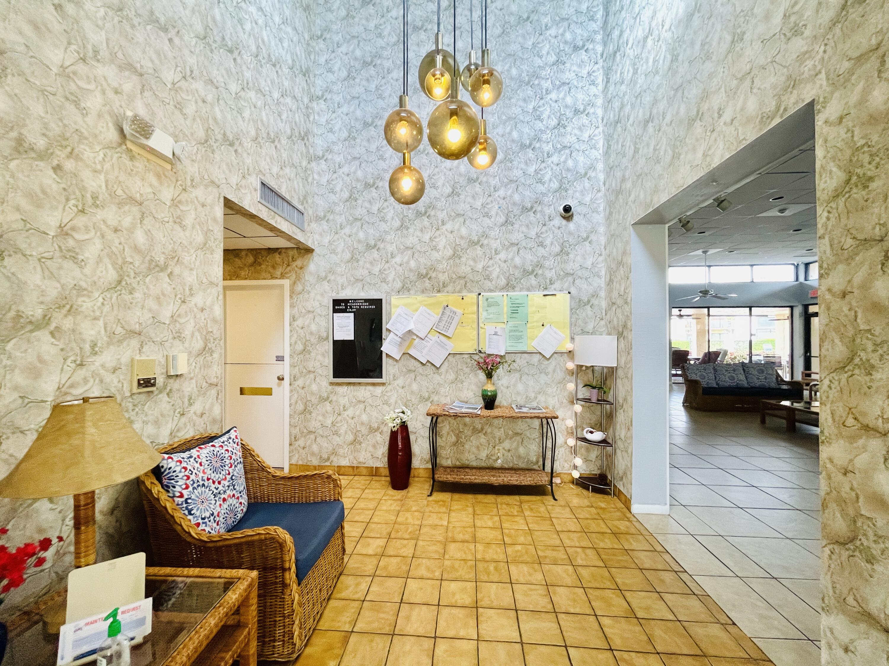 2297 Southwest 15th Street, Unit 122 Deerfield Beach, FL 33442 - Photo 46 of 47 a lobby with furniture and wooden floor