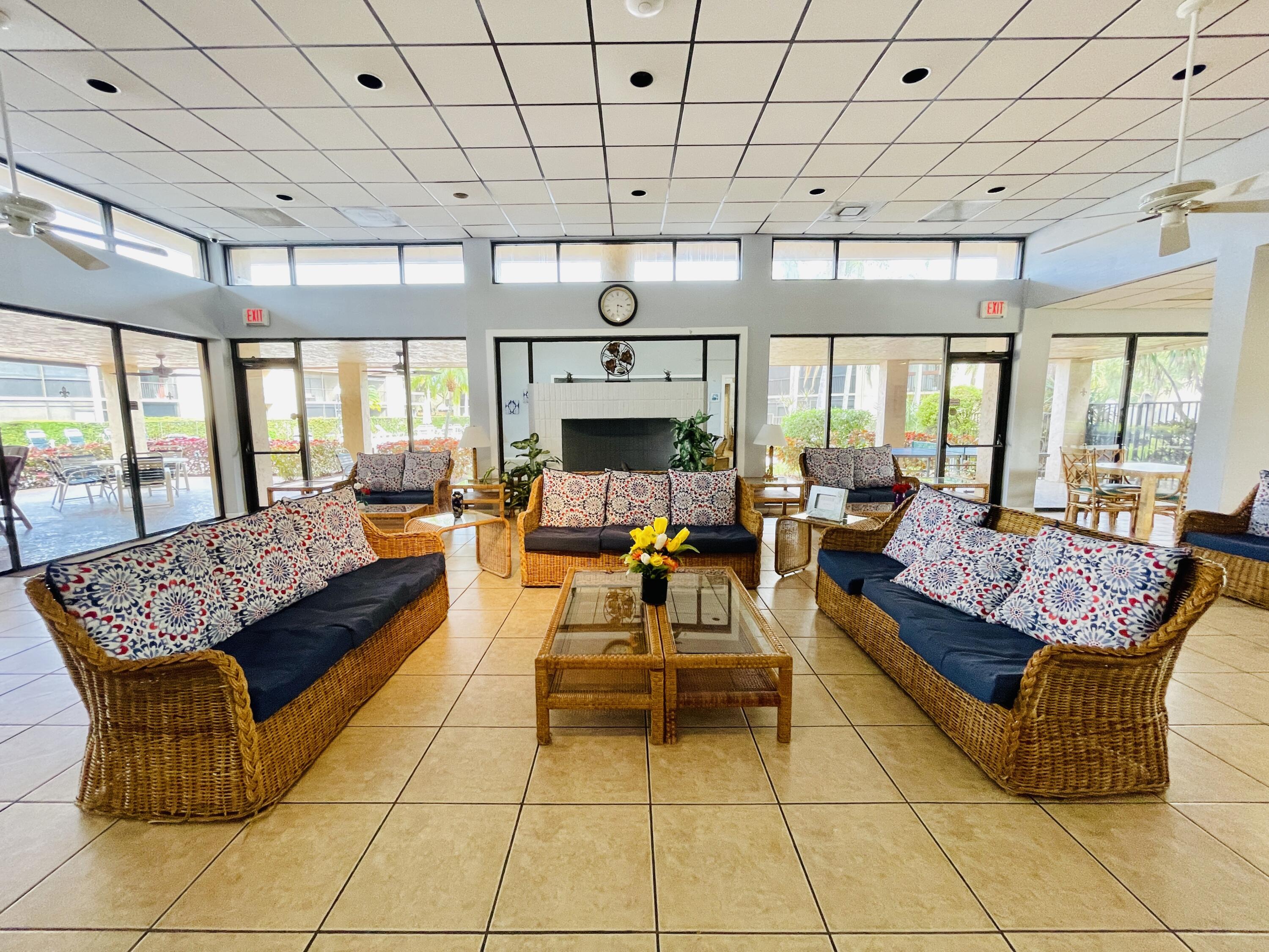 2297 Southwest 15th Street, Unit 122 Deerfield Beach, FL 33442 - Photo 47 of 47 a living room with patio furniture and a fireplace
