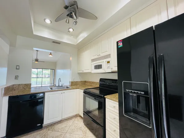 a kitchen with a sink stainless steel appliances and cabinets