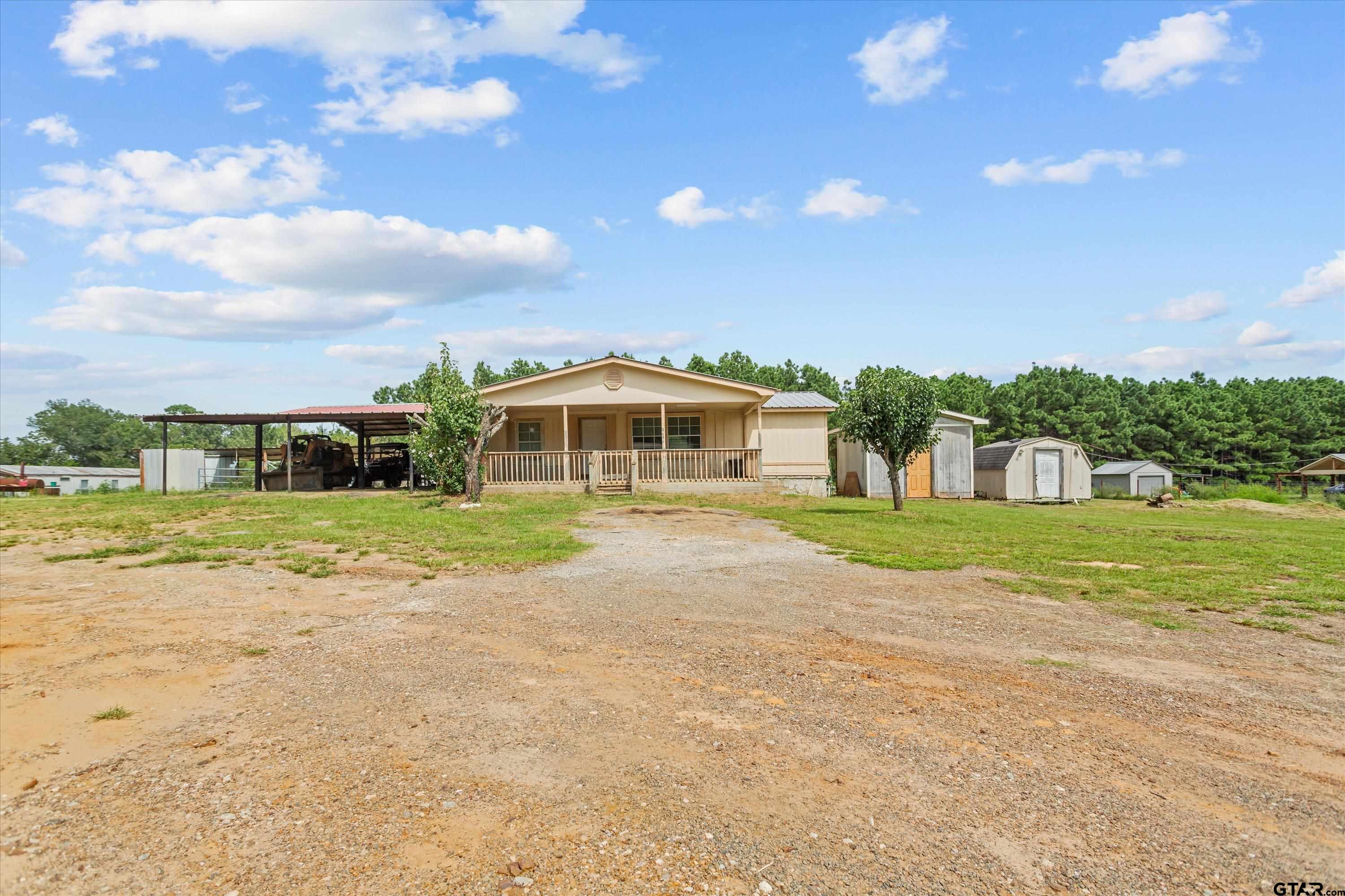 9374 Cedarvale Drive Tyler, TX 75708 - Photo 2 of 20 a view of house with yard and outdoor space