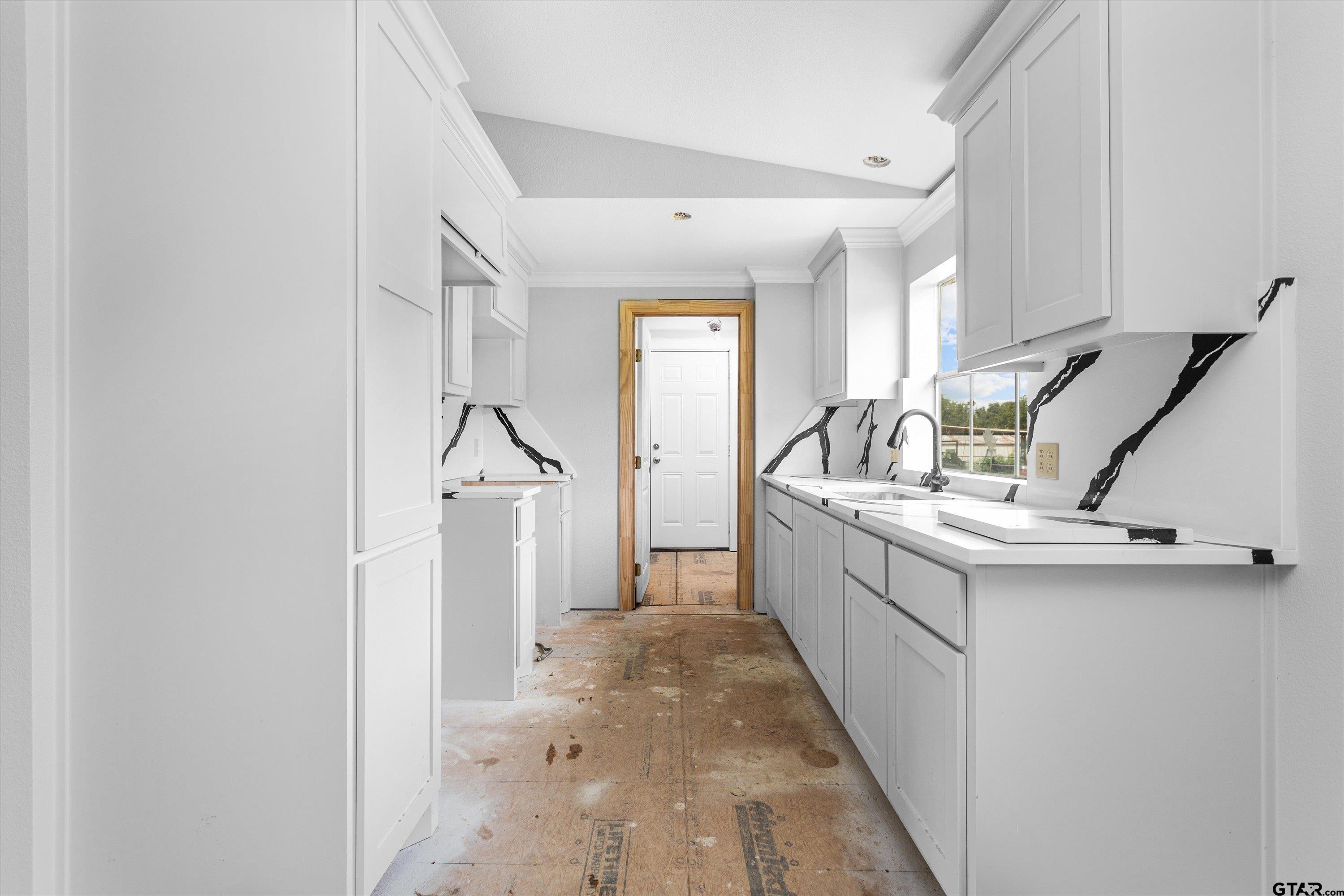9374 Cedarvale Drive Tyler, TX 75708 - Photo 9 of 20 a kitchen with a sink a refrigerator and cabinets