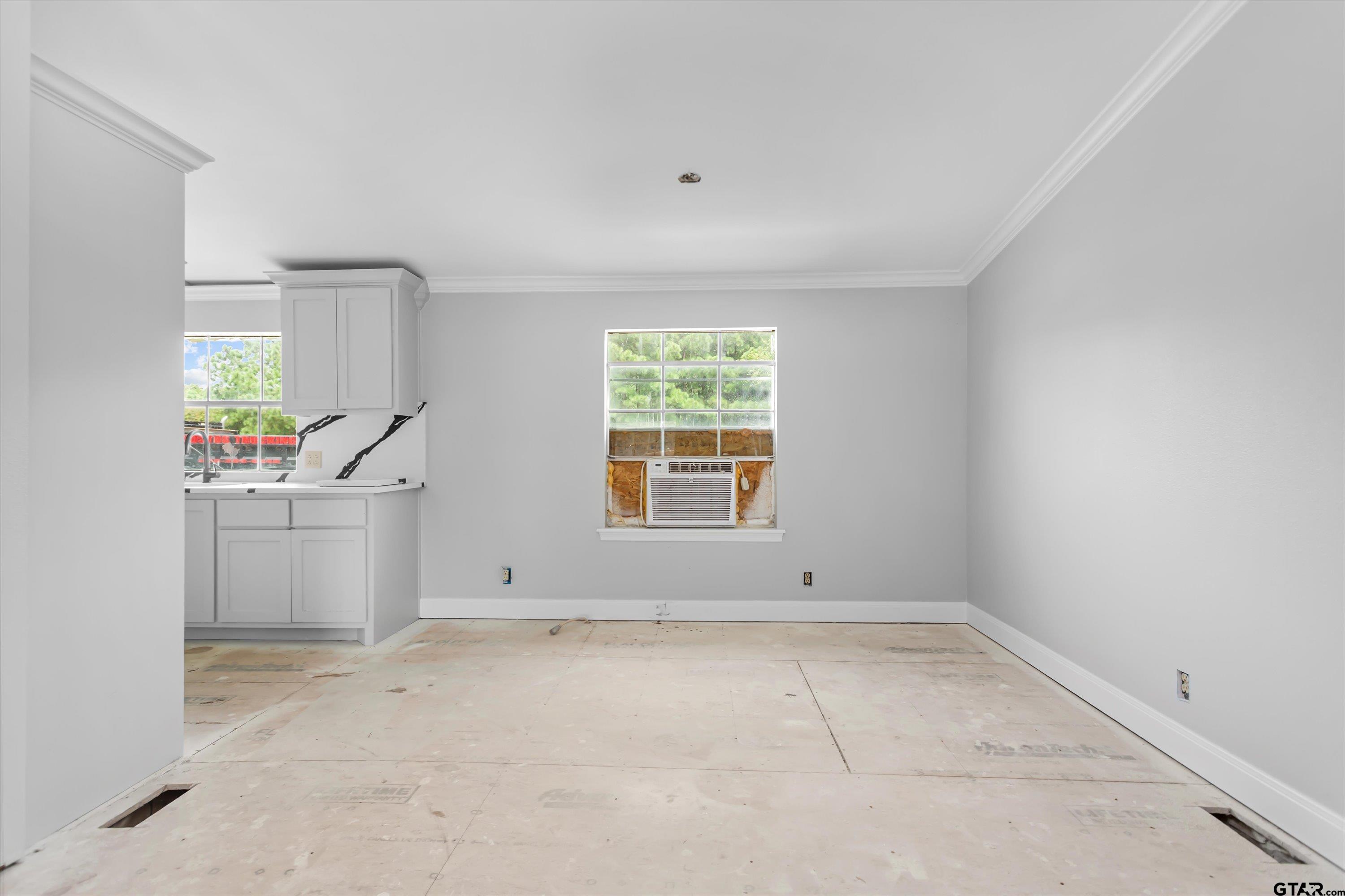 9374 Cedarvale Drive Tyler, TX 75708 - Photo 10 of 20 an empty room with windows and cabinet