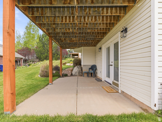 6849 North Black Powder Road Mountain Green, UT 84050 - Photo 30 of 43 Covered concrete patio with wooden support columns