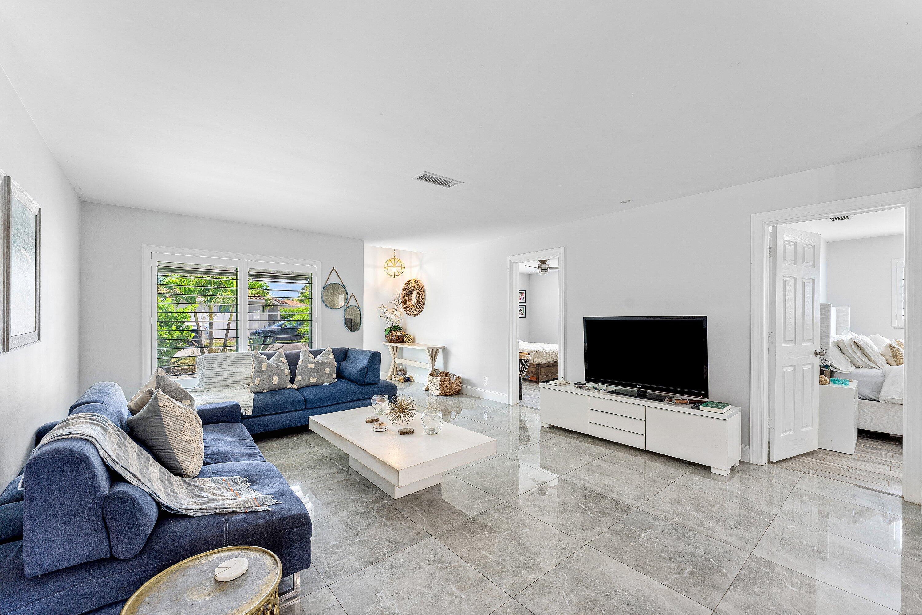 581 Northwest 13th Drive Boca Raton, FL 33486 - Photo 7 of 39 a living room with furniture and a flat screen tv