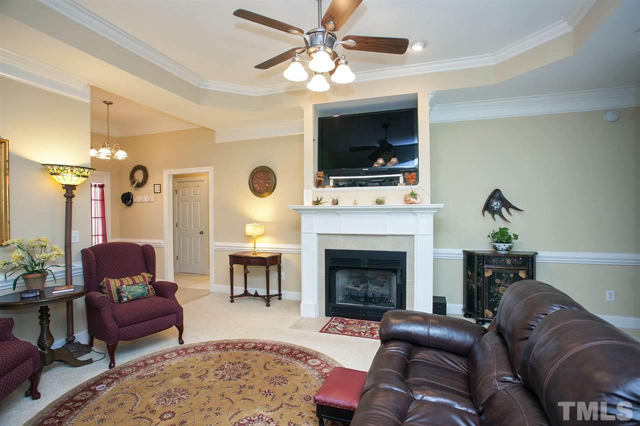 11551 Rockside Road Middlesex, NC 27557 - Photo 2 of 25 a living room with furniture a flat screen tv and a fireplace
