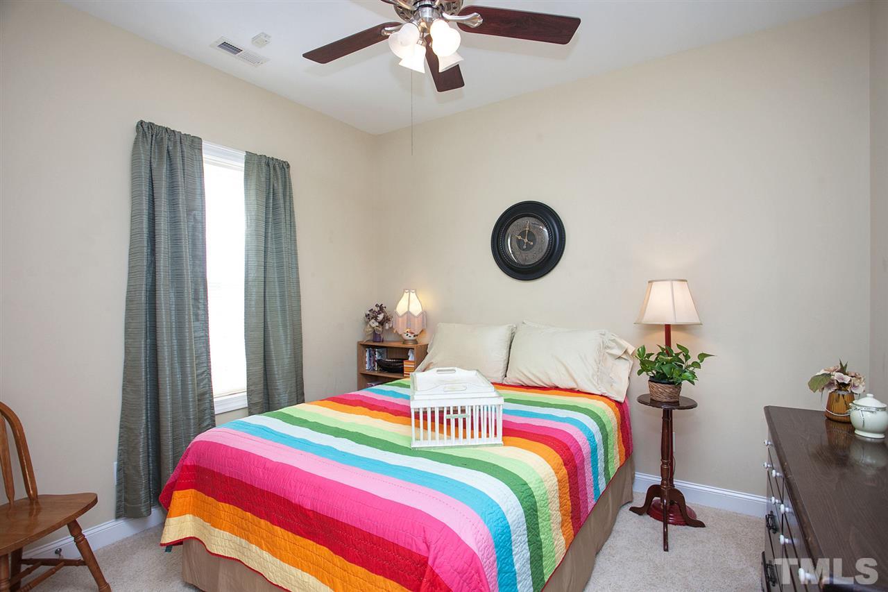 11551 Rockside Road Middlesex, NC 27557 - Photo 14 of 25 a bedroom with bed and a chandelier