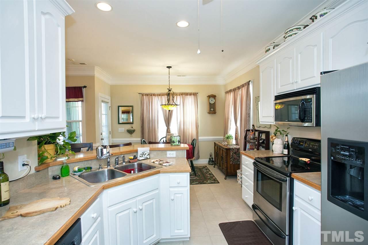 11551 Rockside Road Middlesex, NC 27557 - Photo 19 of 25 a kitchen with stainless steel appliances a stove sink microwave refrigerator and cabinets