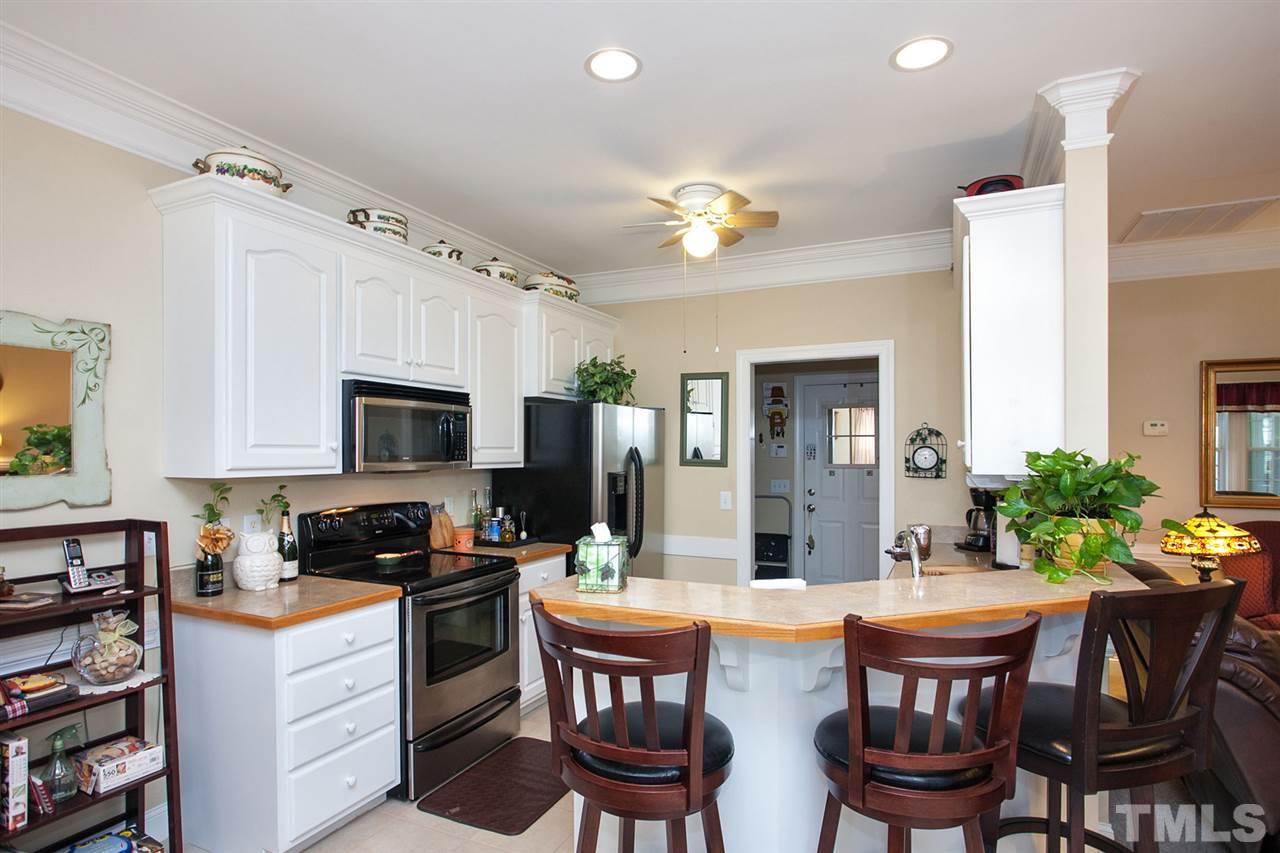 11551 Rockside Road Middlesex, NC 27557 - Photo 3 of 25 a kitchen with a table chairs stove and cabinets
