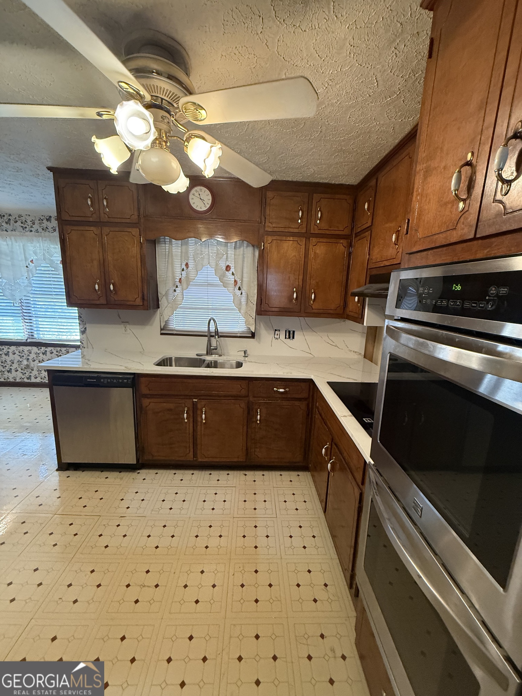 110 Otelia Lane Covington, GA 30014 - Photo 16 of 30 a kitchen with a stove a sink and a refrigerator