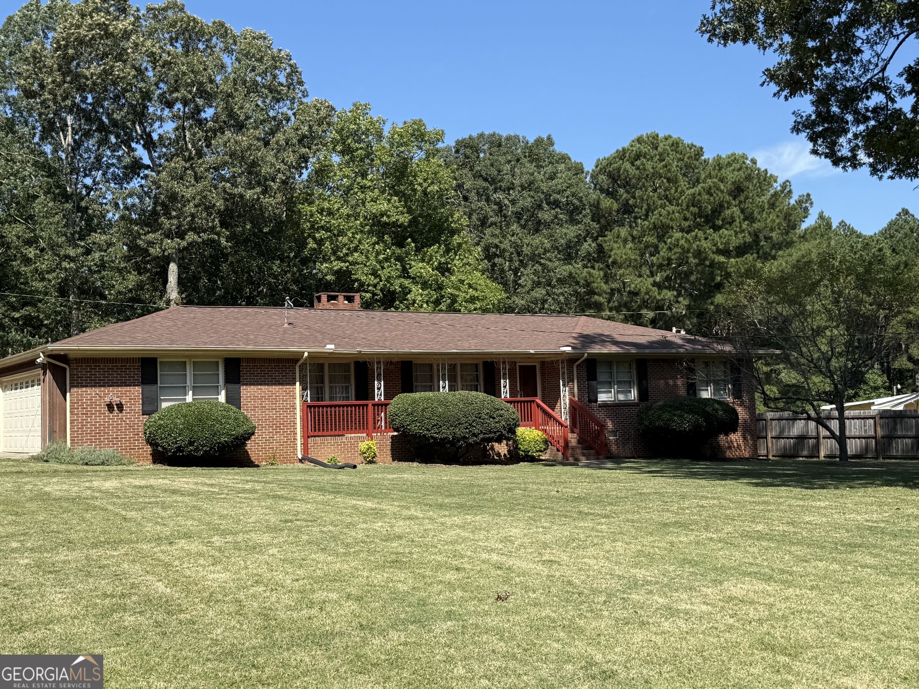 110 Otelia Lane Covington, GA 30014 - Photo 2 of 9 a front view of a house with a garden and trees