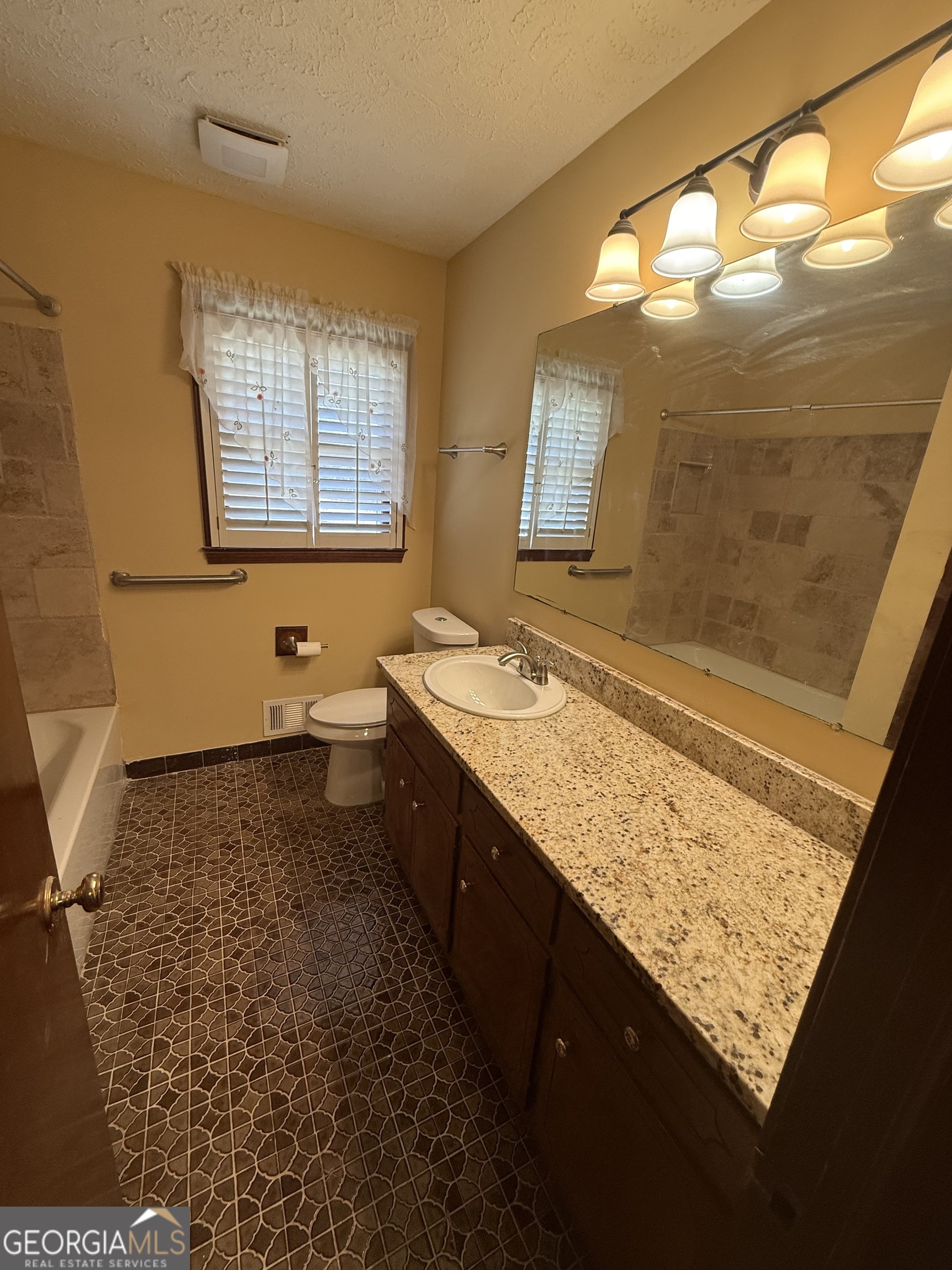 110 Otelia Lane Covington, GA 30014 - Photo 24 of 30 a bathroom with a granite countertop sink toilet and mirror
