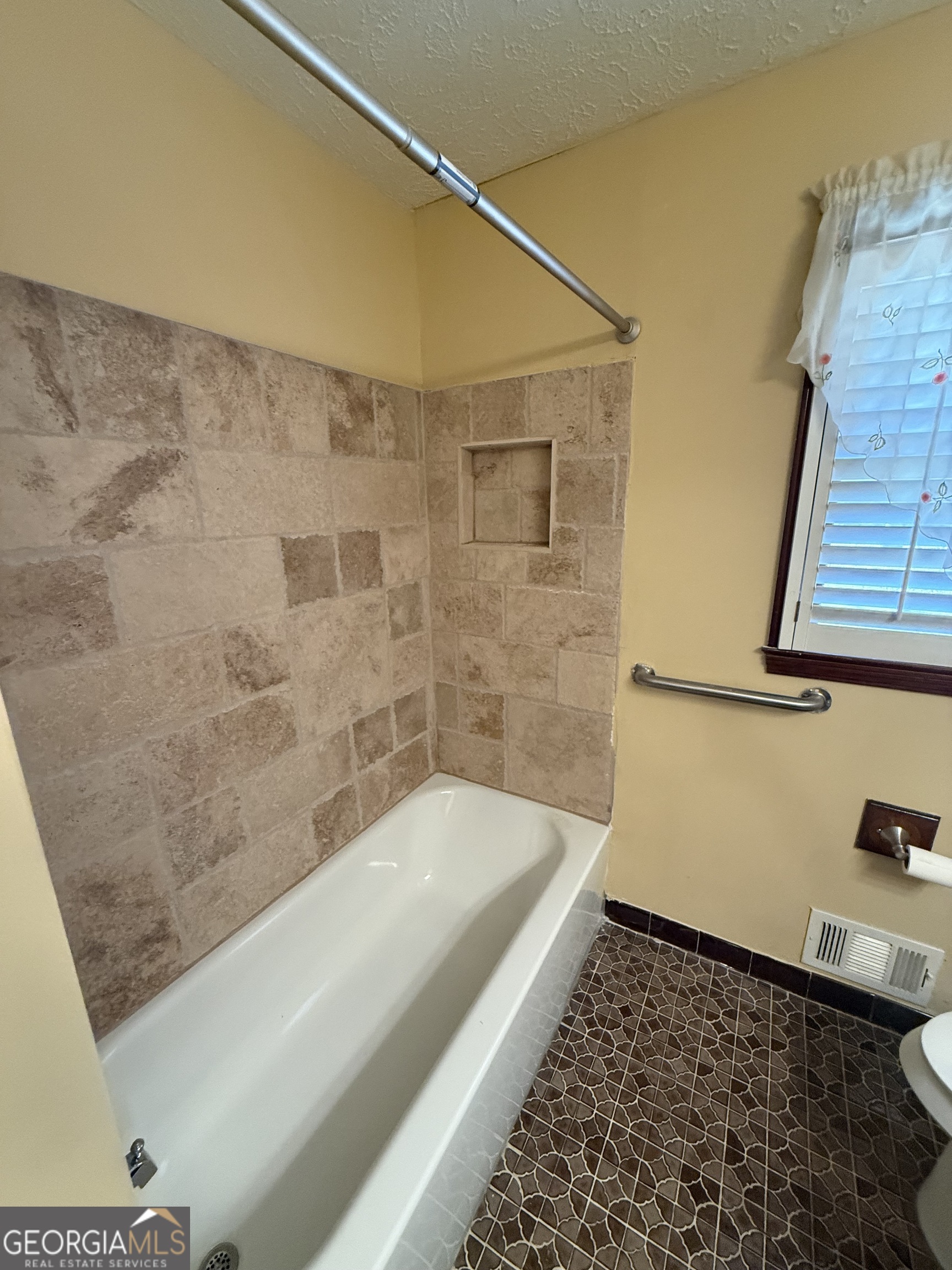 110 Otelia Lane Covington, GA 30014 - Photo 25 of 30 a bathroom with a bathtub and shower